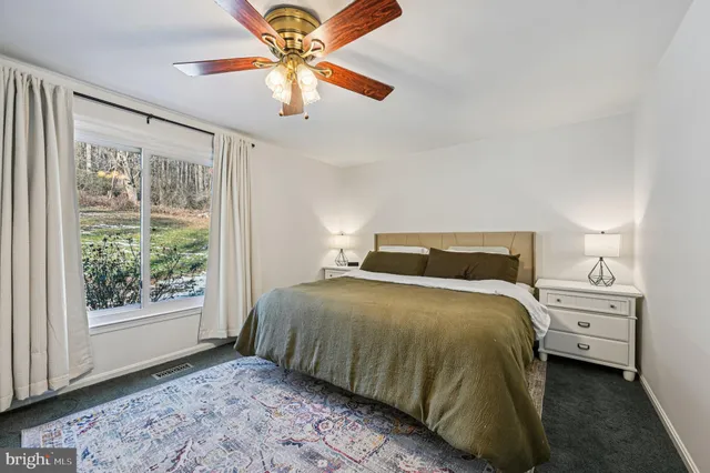 a bathroom with a sink a toilet and shower curtain