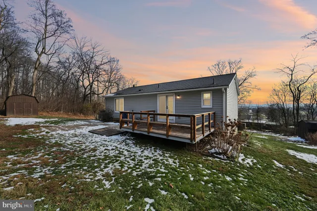 a view of a house with a yard and sitting area