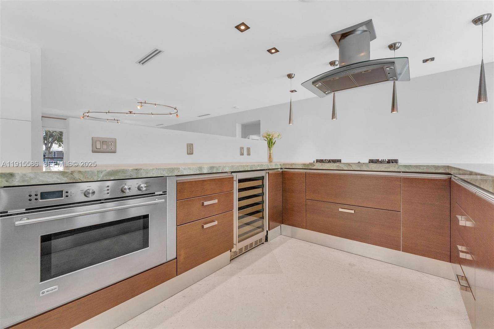 7261 West Troon Circle Miami Lakes, FL 33014 - Photo 15 of 61 a kitchen with a stove and cabinets