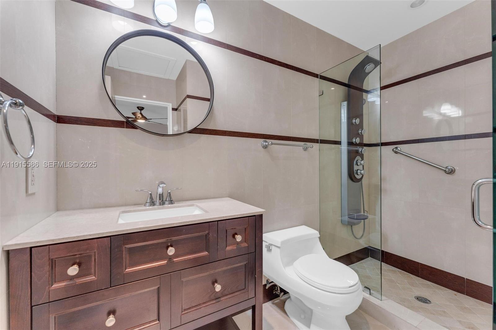 7261 West Troon Circle Miami Lakes, FL 33014 - Photo 36 of 61 a bathroom with a granite countertop sink a toilet and a mirror