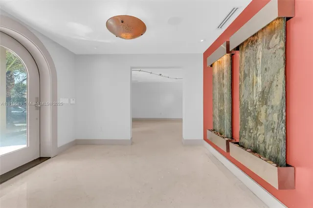 a large white kitchen with a large window