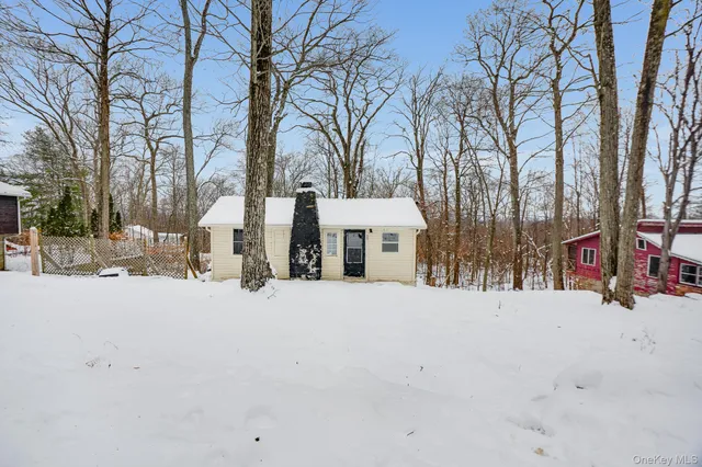 a front view of a building with trees
