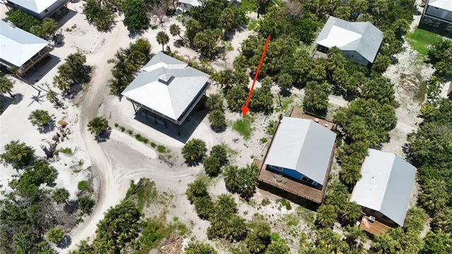 an aerial view of a house with a yard and lake view