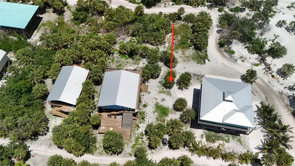 an aerial view of a house with a yard and trees
