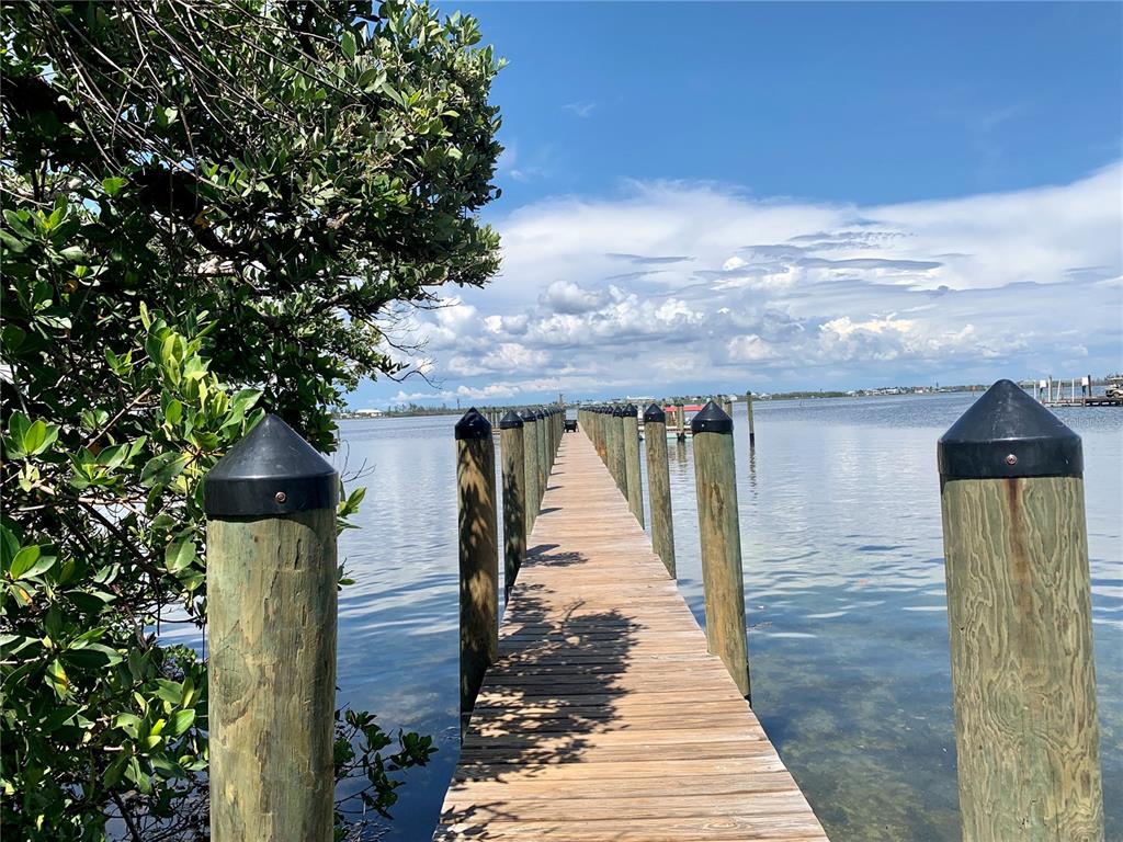 8964 Seagrape Lane Boca Grande, FL 33921 - Photo 6 of 20 a front view of a house with wooden fence