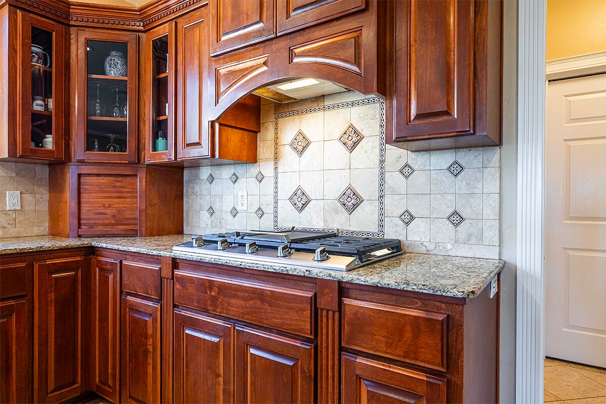 3343 Lone Pine Road Medford, OR 97504 - Photo 36 of 47 Dacor Cooktop, Glass Front Cabinets, Appliance Garage & Full-Height Tile Backsplash