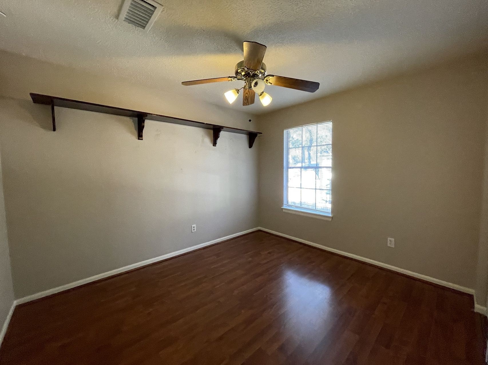 88 West Rainbow Ridge Circle The Woodlands, TX 77381 - Photo 13 of 16 a view of an empty room with wooden floor and a window