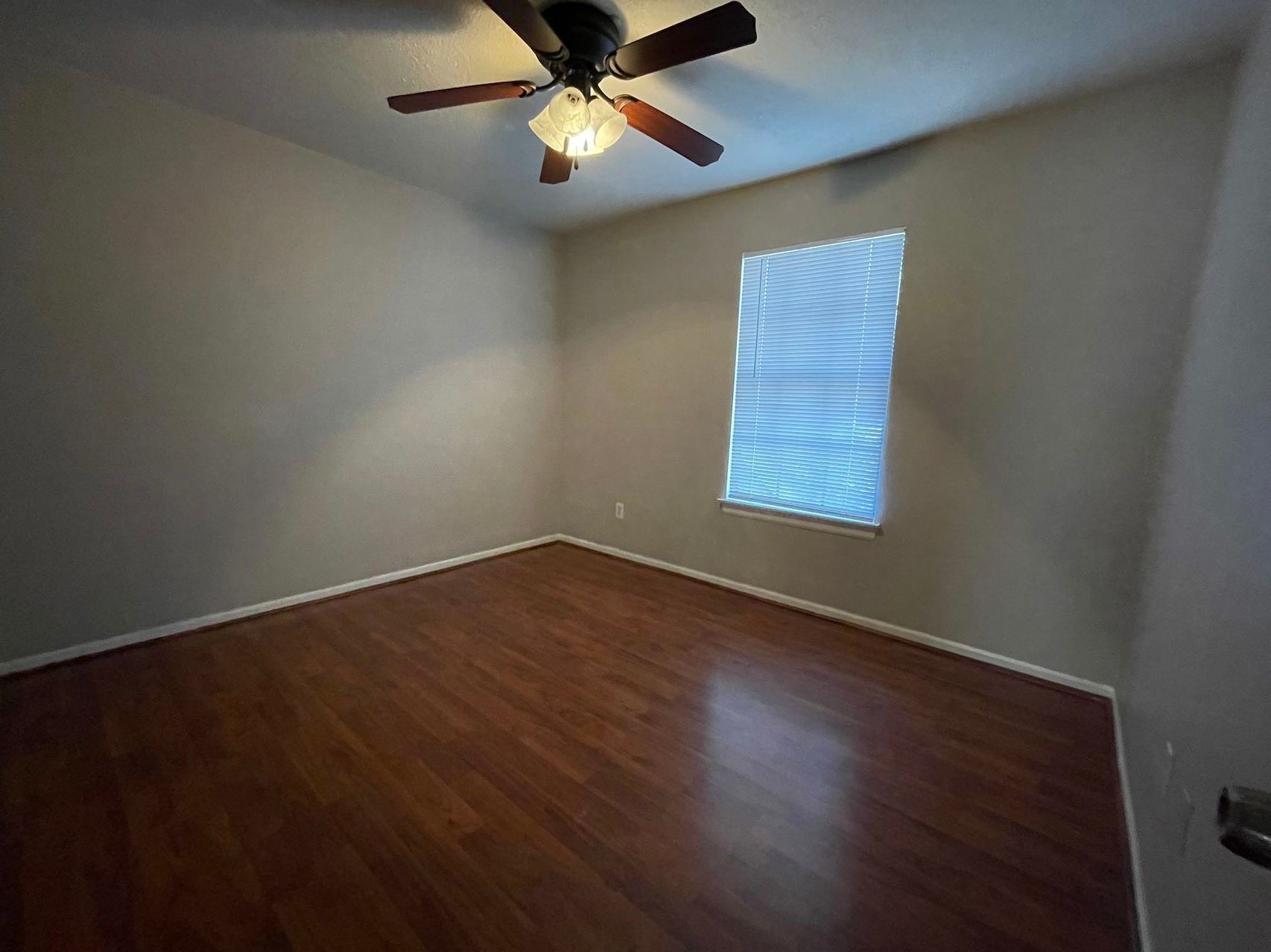 88 West Rainbow Ridge Circle The Woodlands, TX 77381 - Photo 14 of 16 a view of an empty room with wooden floor and a window