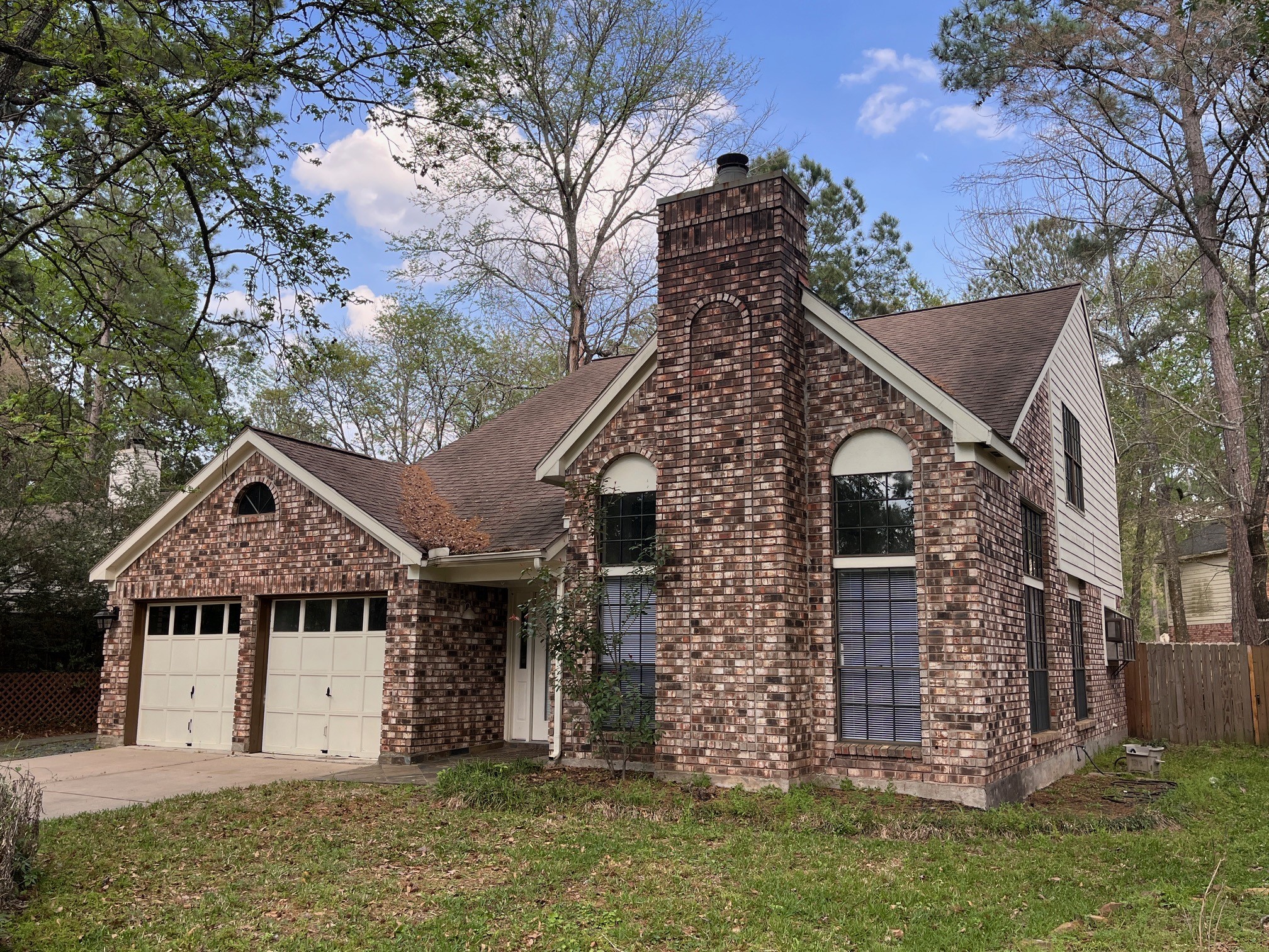 88 West Rainbow Ridge Circle The Woodlands, TX 77381 - Photo 2 of 16 a view of a house with a yard