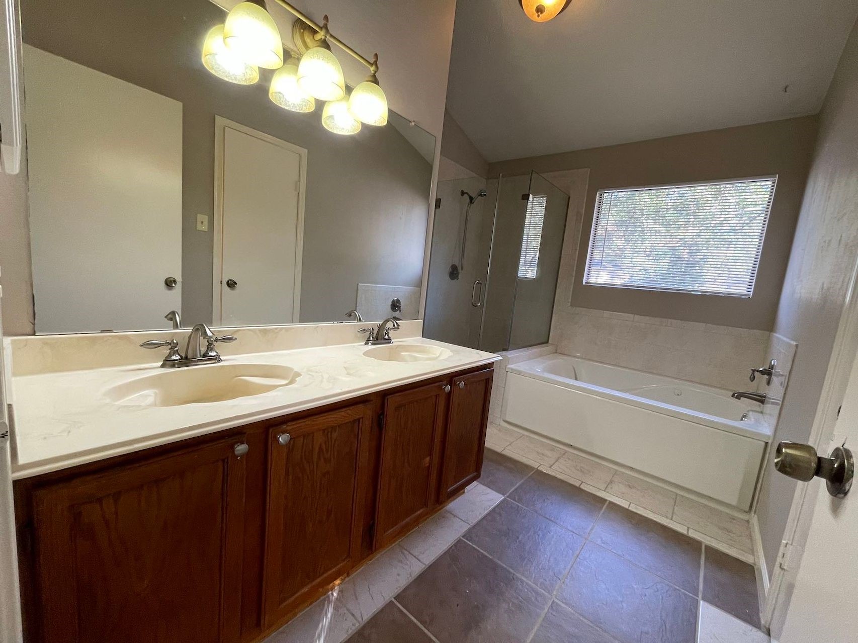 88 West Rainbow Ridge Circle The Woodlands, TX 77381 - Photo 5 of 16 a bathroom with a double vanity sink a tub and a mirror
