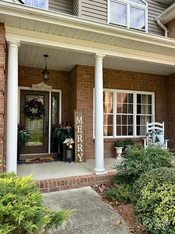 a living room with furniture a fireplace and a floor to ceiling window