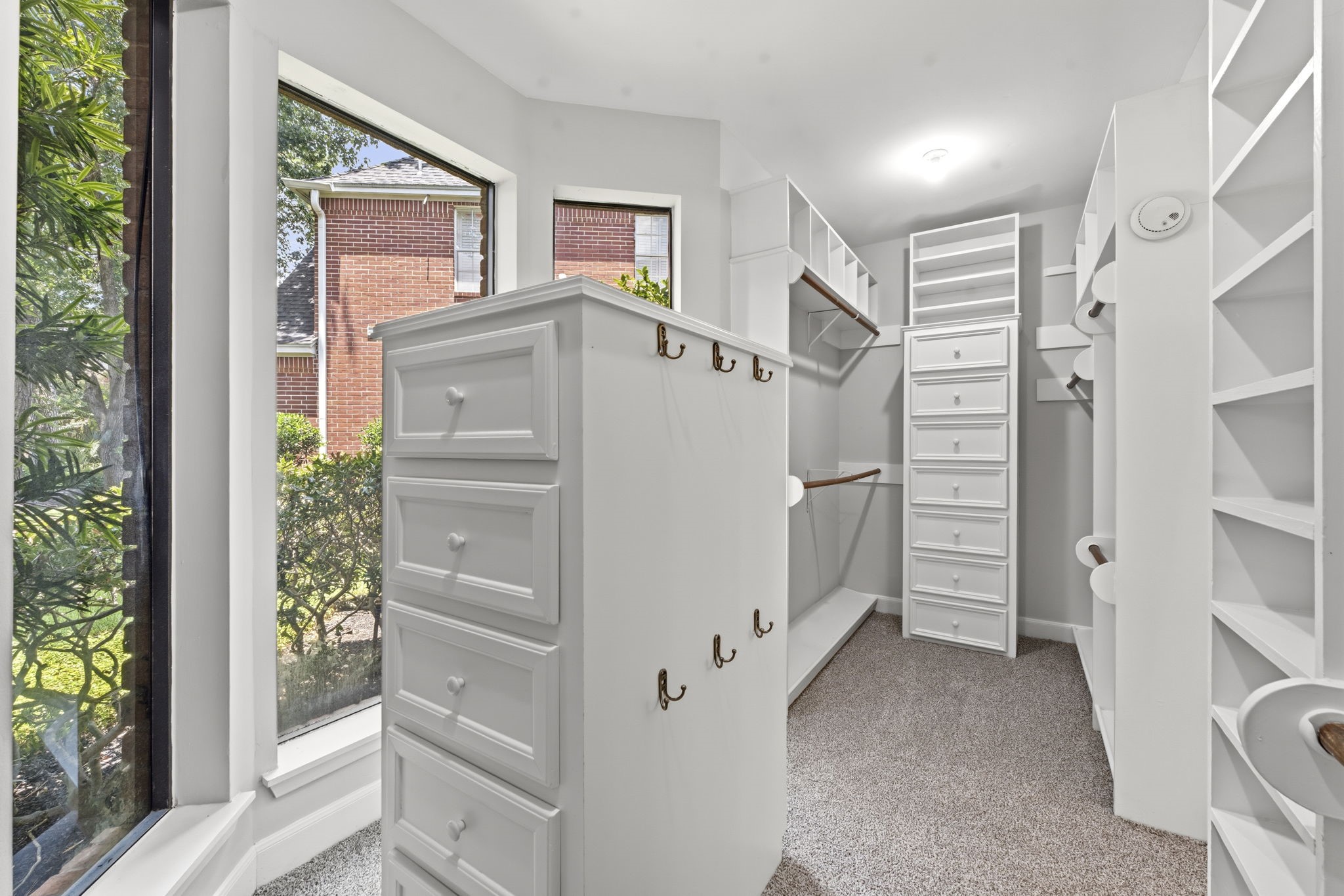 18503 Cabaniss Circle Spring, TX 77379 - Photo 29 of 49 Large walk-in closet with extensive built-in shelving, drawers, hanging space, and windows that fill the space with natural light.