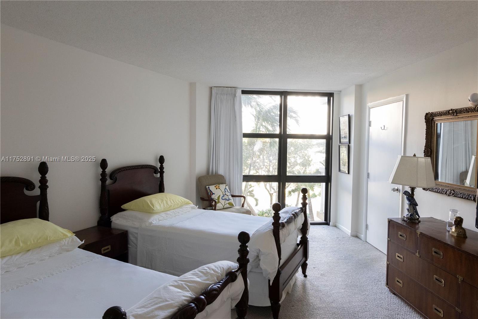 1121 Crandon Boulevard, Unit E203 Key Biscayne, FL 33149 - Photo 11 of 22 a living room with furniture and a flat screen tv