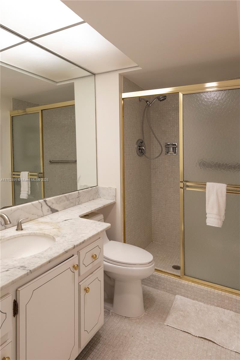 1121 Crandon Boulevard, Unit E203 Key Biscayne, FL 33149 - Photo 13 of 22 a bathroom with a sink toilet and shower