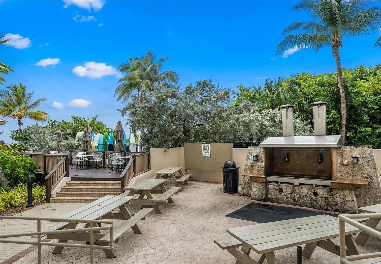 1121 Crandon Boulevard, Unit E203 Key Biscayne, FL 33149 - Photo 19 of 22 a view of a tables and chairs in patio