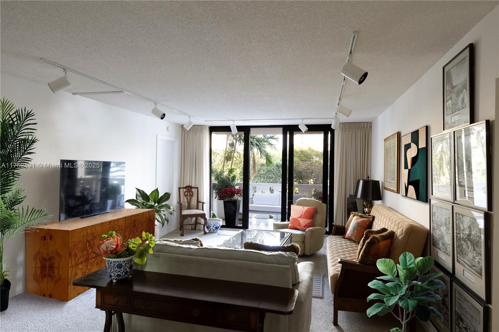 1121 Crandon Boulevard, Unit E203 Key Biscayne, FL 33149 - Photo 2 of 22 a living room with furniture fireplace and flat screen tv