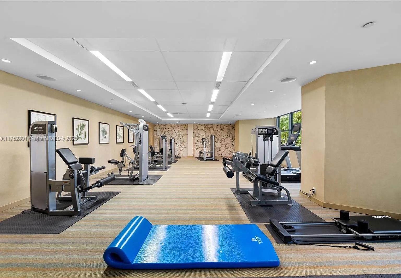 1121 Crandon Boulevard, Unit E203 Key Biscayne, FL 33149 - Photo 22 of 22 a room with lots of furniture and wooden floors