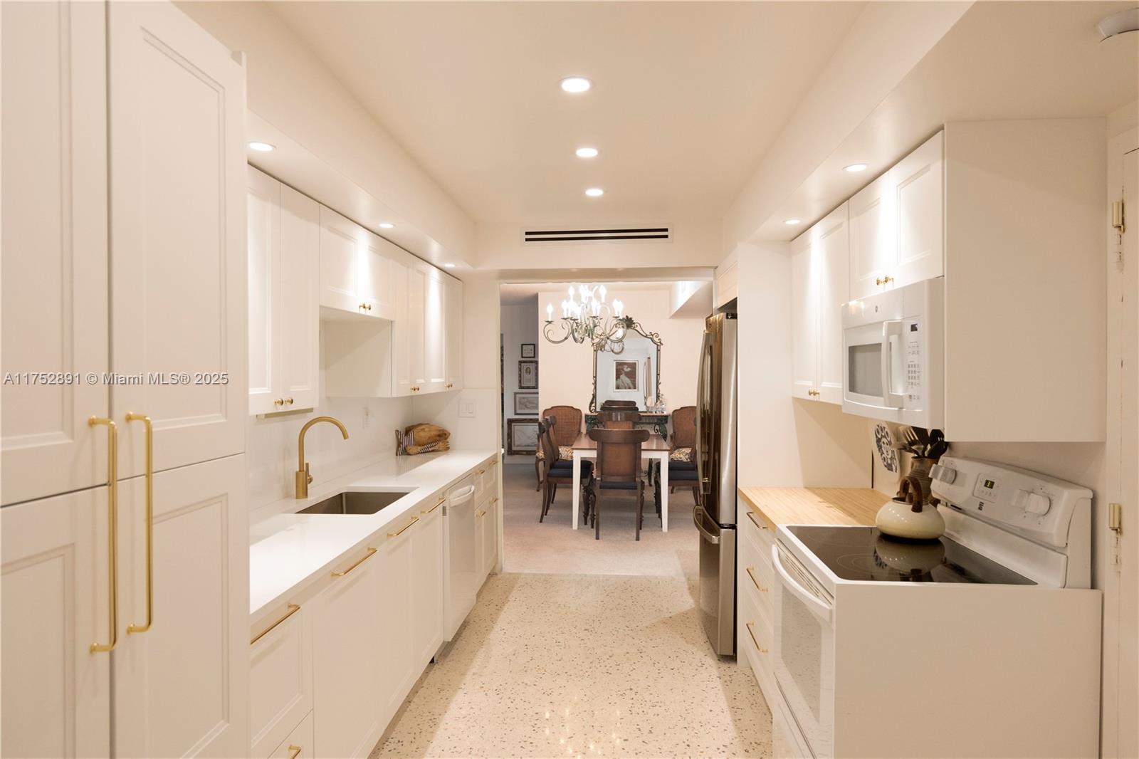 1121 Crandon Boulevard, Unit E203 Key Biscayne, FL 33149 - Photo 5 of 22 a large white kitchen with a large window