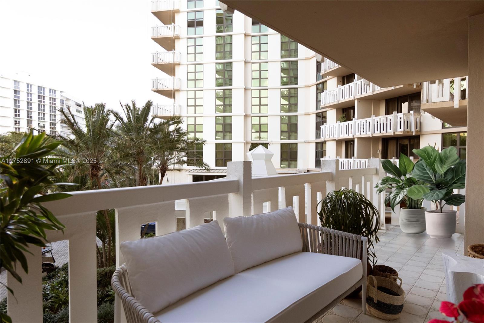 1121 Crandon Boulevard, Unit E203 Key Biscayne, FL 33149 - Photo 7 of 22 a balcony with table and chairs