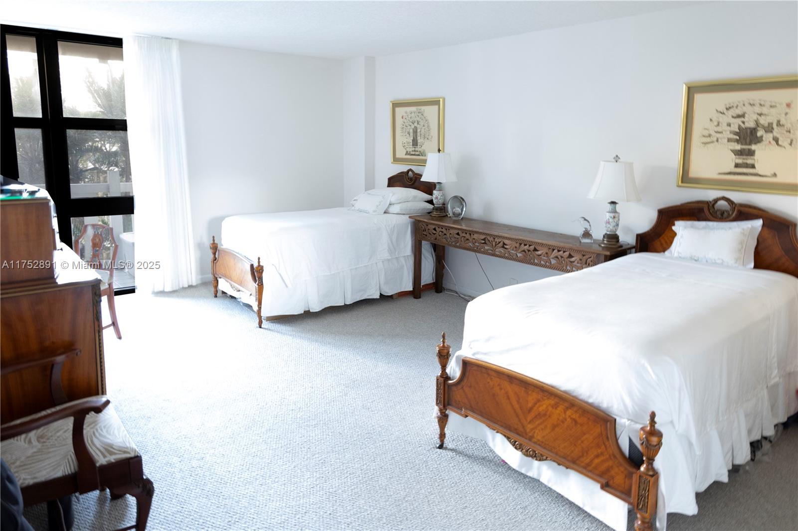 1121 Crandon Boulevard, Unit E203 Key Biscayne, FL 33149 - Photo 8 of 22 a bedroom with bed and window