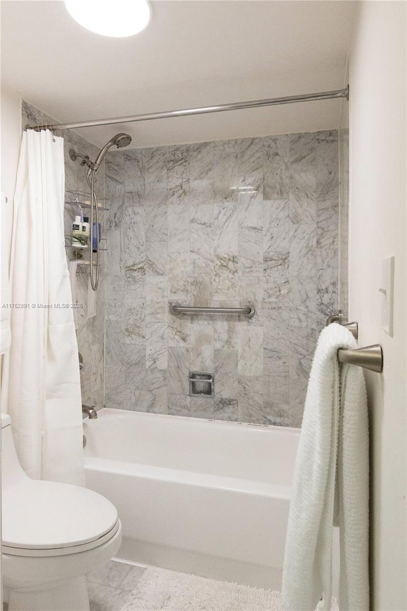 1121 Crandon Boulevard, Unit E203 Key Biscayne, FL 33149 - Photo 10 of 22 a bathroom with a shower and a toilet