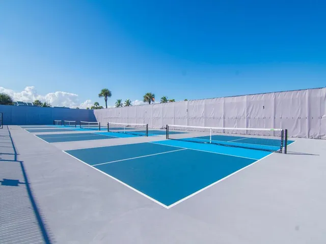 a view of backyard with a table and chairs under an umbrella