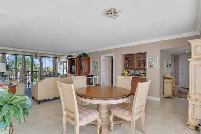 a dining room with furniture potted plants and wooden floor