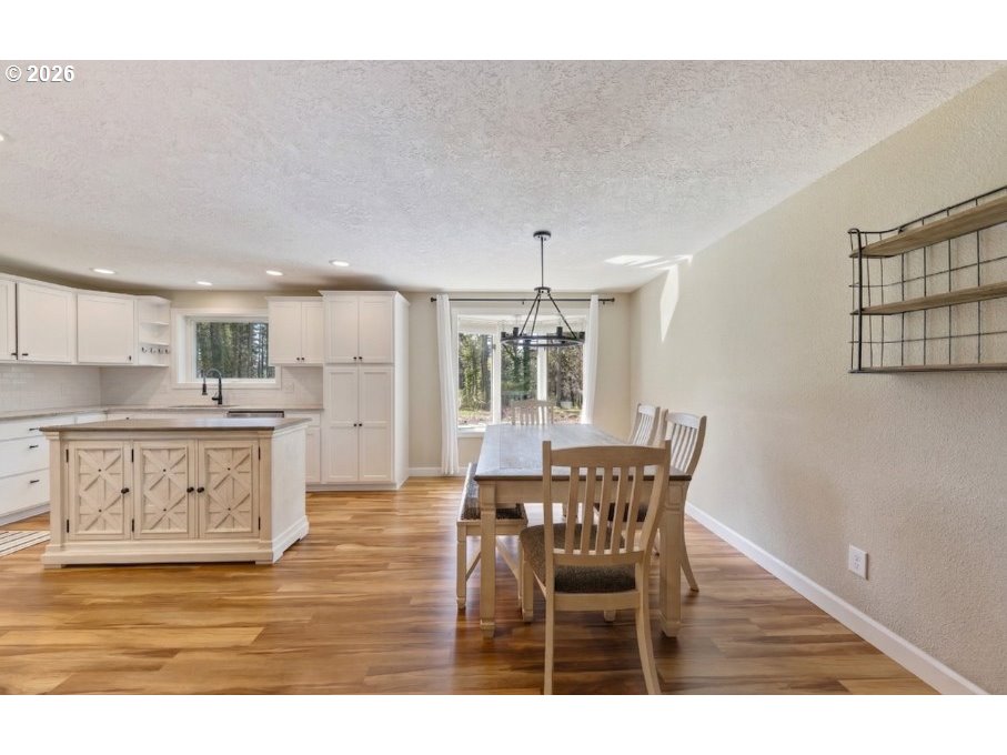 7624 Shady Way Southeast Turner, OR 97392 - Photo 11 of 48 a view of a dining room with furniture and wooden floor
