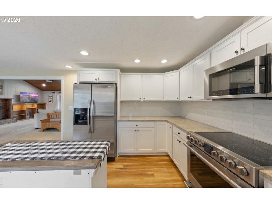 7624 Shady Way Southeast Turner, OR 97392 - Photo 15 of 48 a kitchen with stainless steel appliances granite countertop a stove a sink and a microwave