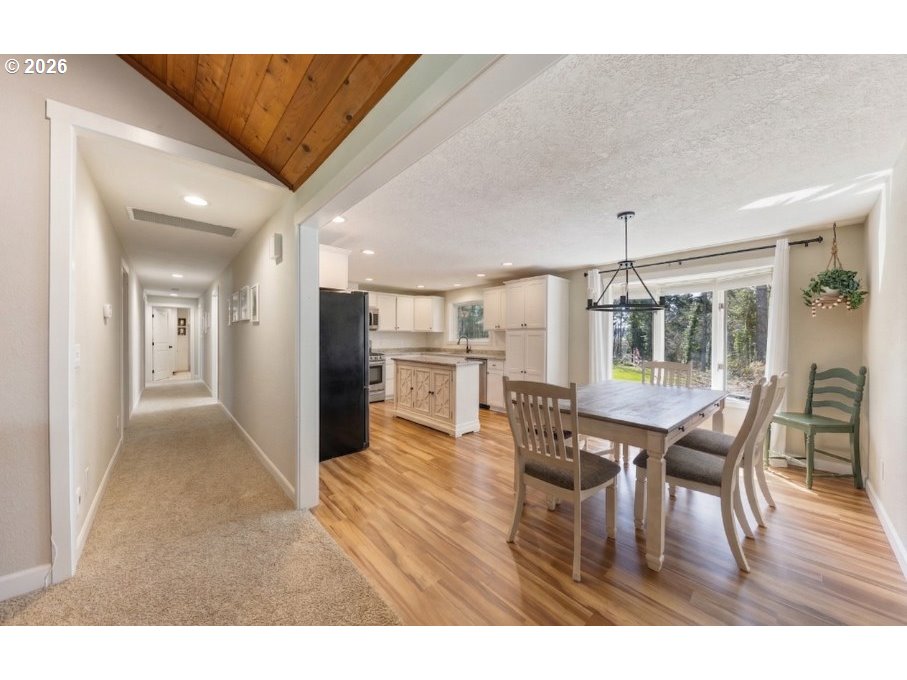 7624 Shady Way Southeast Turner, OR 97392 - Photo 18 of 48 a view of a dining room with furniture and wooden floor