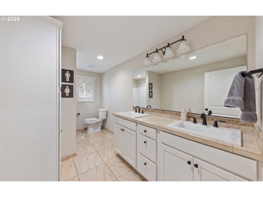 7624 Shady Way Southeast Turner, OR 97392 - Photo 28 of 48 a bathroom with a double vanity sink and mirror