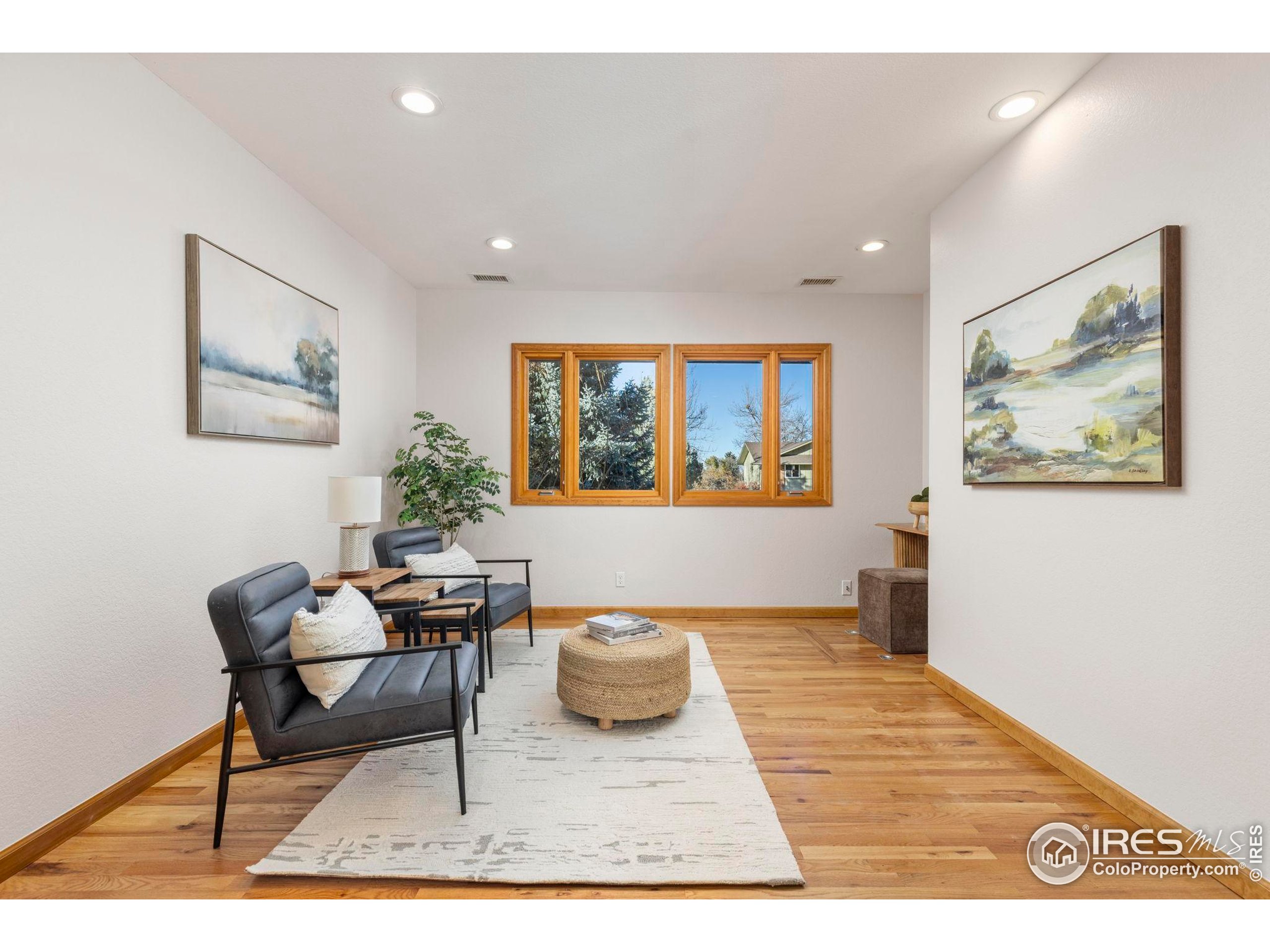 7238 Mt Sherman Road Longmont, CO 80503 - Photo 12 of 48 a living room with furniture and a wooden floor