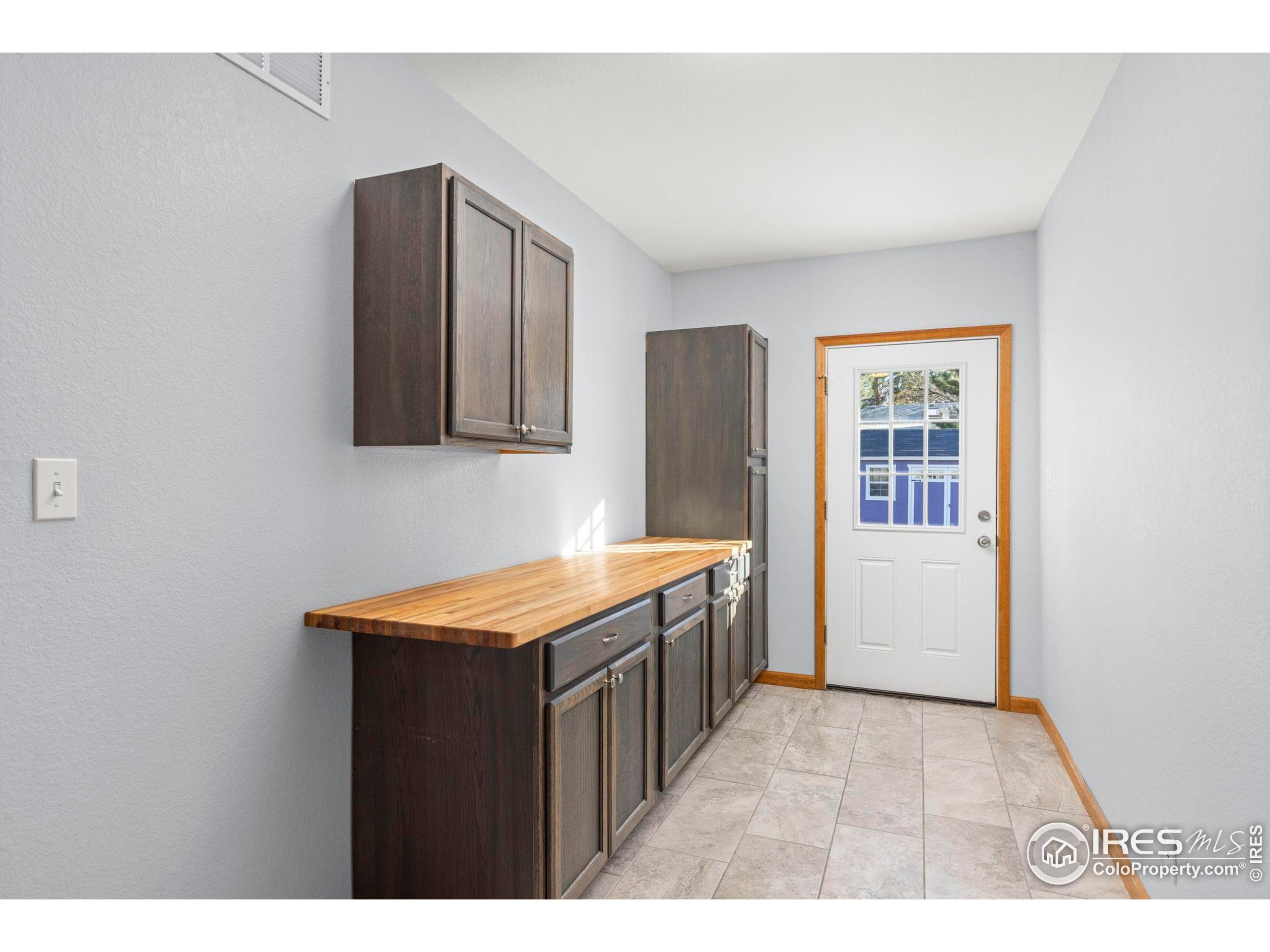 7238 Mt Sherman Road Longmont, CO 80503 - Photo 15 of 48 a kitchen with stainless steel appliances granite countertop a refrigerator and a sink