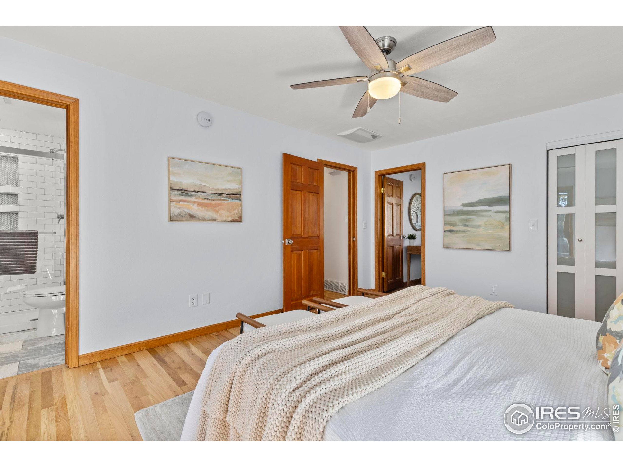 7238 Mt Sherman Road Longmont, CO 80503 - Photo 18 of 48 a bedroom with a large bed and a chandelier