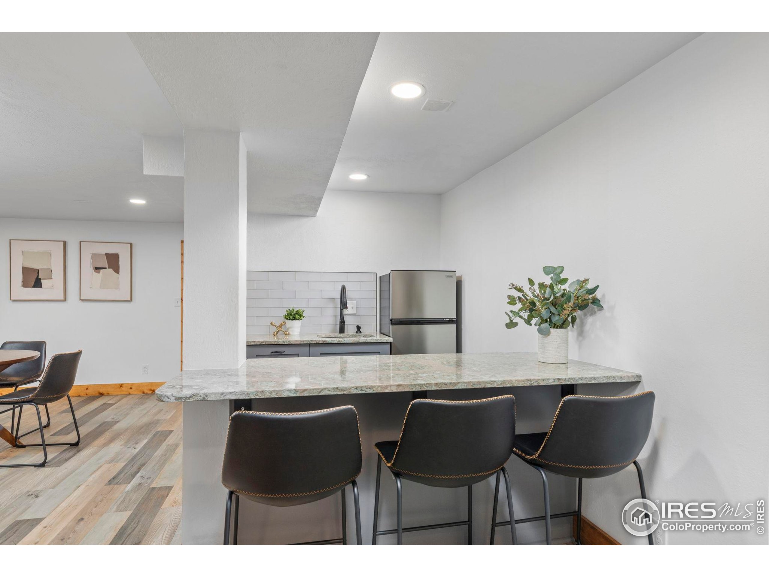 7238 Mt Sherman Road Longmont, CO 80503 - Photo 27 of 48 a kitchen with a table chairs refrigerator and cabinets