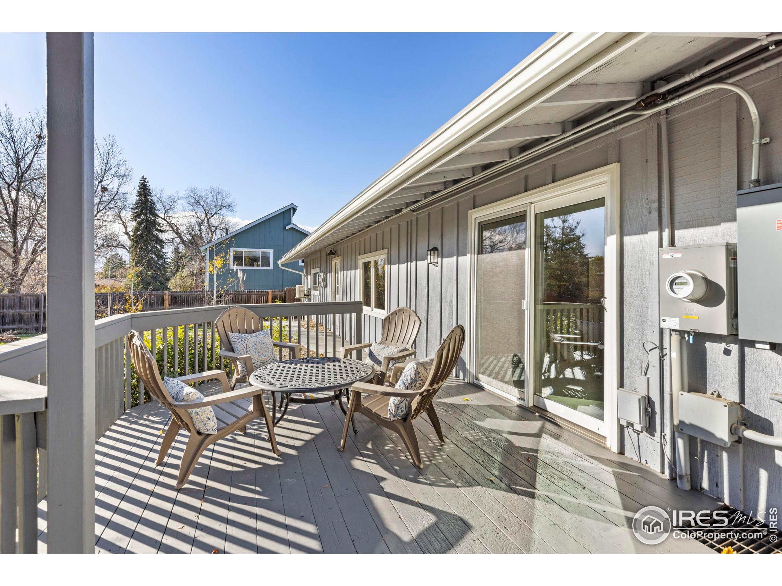 7238 Mt Sherman Road Longmont, CO 80503 - Photo 35 of 48 a balcony with wooden floor table and chairs