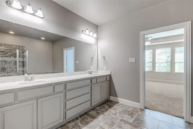 a bathroom with a double vanity sink and a mirror