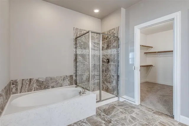 a bathroom with a bathtub and a shower