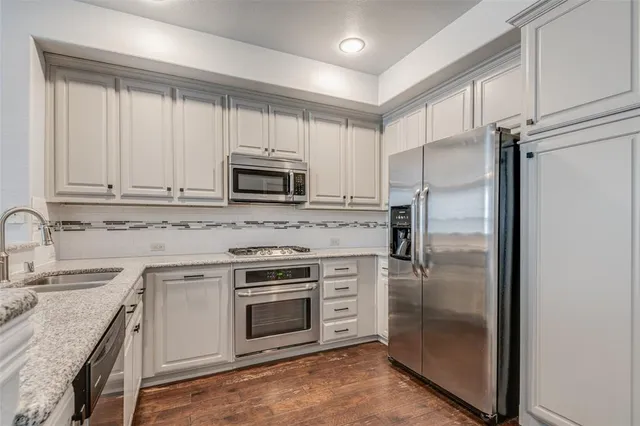 a kitchen with a sink stove and refrigerator