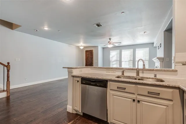 a kitchen with a sink cabinets and wooden floor