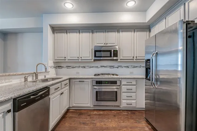 a kitchen with a sink stove and refrigerator
