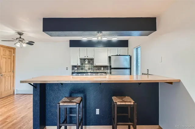 a kitchen with stainless steel appliances a sink and a refrigerator