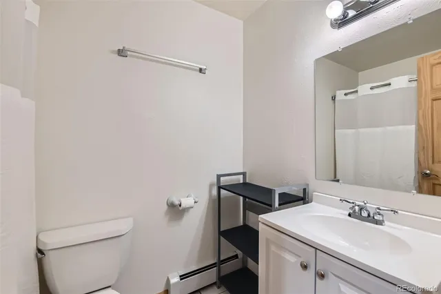 a bathroom with a sink a toilet and vanity