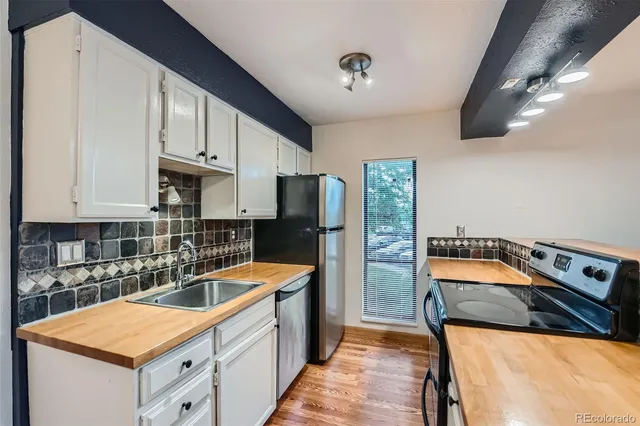 a kitchen that has a sink and a stove in it