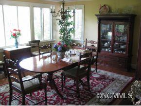 390 Sourwood Ridge Road Tryon, NC 28782 - Photo 2 of 6 a view of a dining room with furniture and window