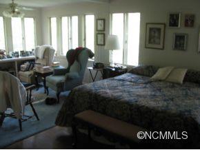 390 Sourwood Ridge Road Tryon, NC 28782 - Photo 4 of 6 a bedroom with a bed and windows