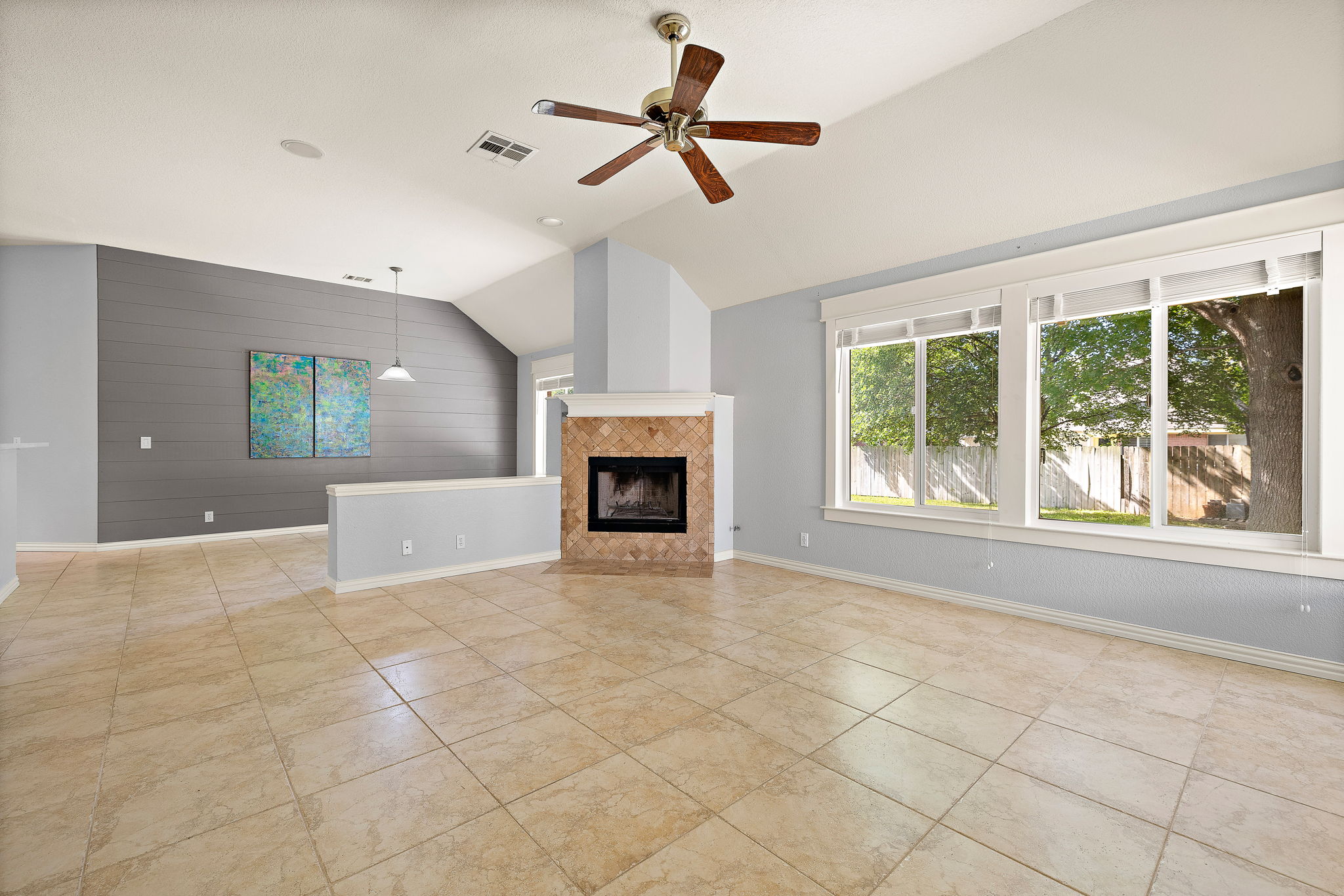 1102 Nelson Ranch Road Cedar Park, TX 78613 - Photo 11 of 37 A living area boasts high ceilings, ample natural light, and a tiled fireplace hearth.