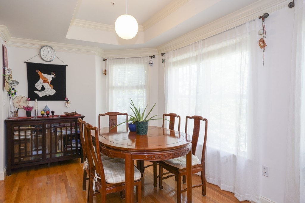 75 Winchester Street, Unit 301 Brookline, MA 02446 - Photo 4 of 8 a view of a dining room with furniture and wooden floor
