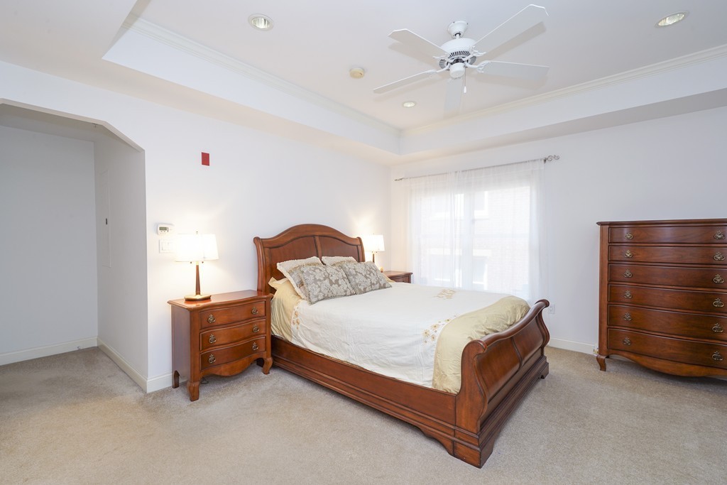 75 Winchester Street, Unit 301 Brookline, MA 02446 - Photo 7 of 8 a bedroom with a bed and dresser