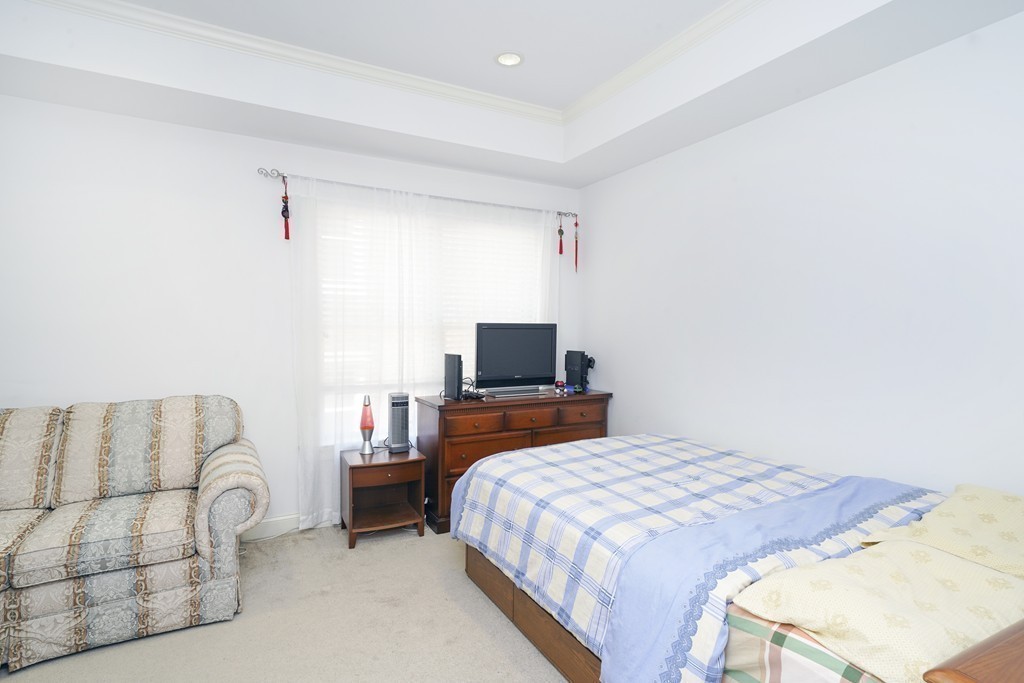 75 Winchester Street, Unit 301 Brookline, MA 02446 - Photo 8 of 8 a bedroom with a bed and a couch